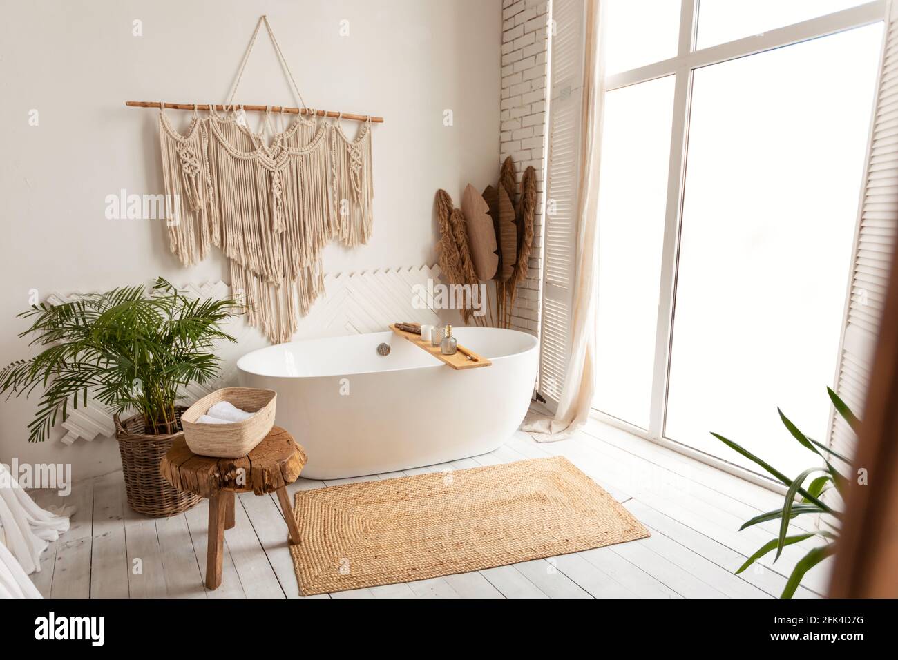 Cozy modern minimalistic bathroom interior with big white bathtube indoors Stock Photo