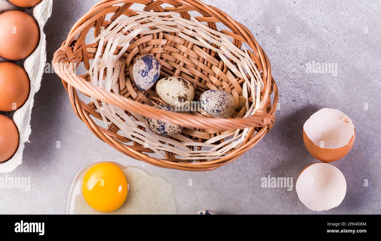 Chicken and quail eggs with basket. Stock Photo