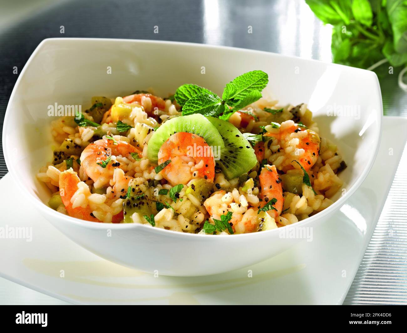 Risotto with prawns and kiwi fruits Stock Photo - Alamy