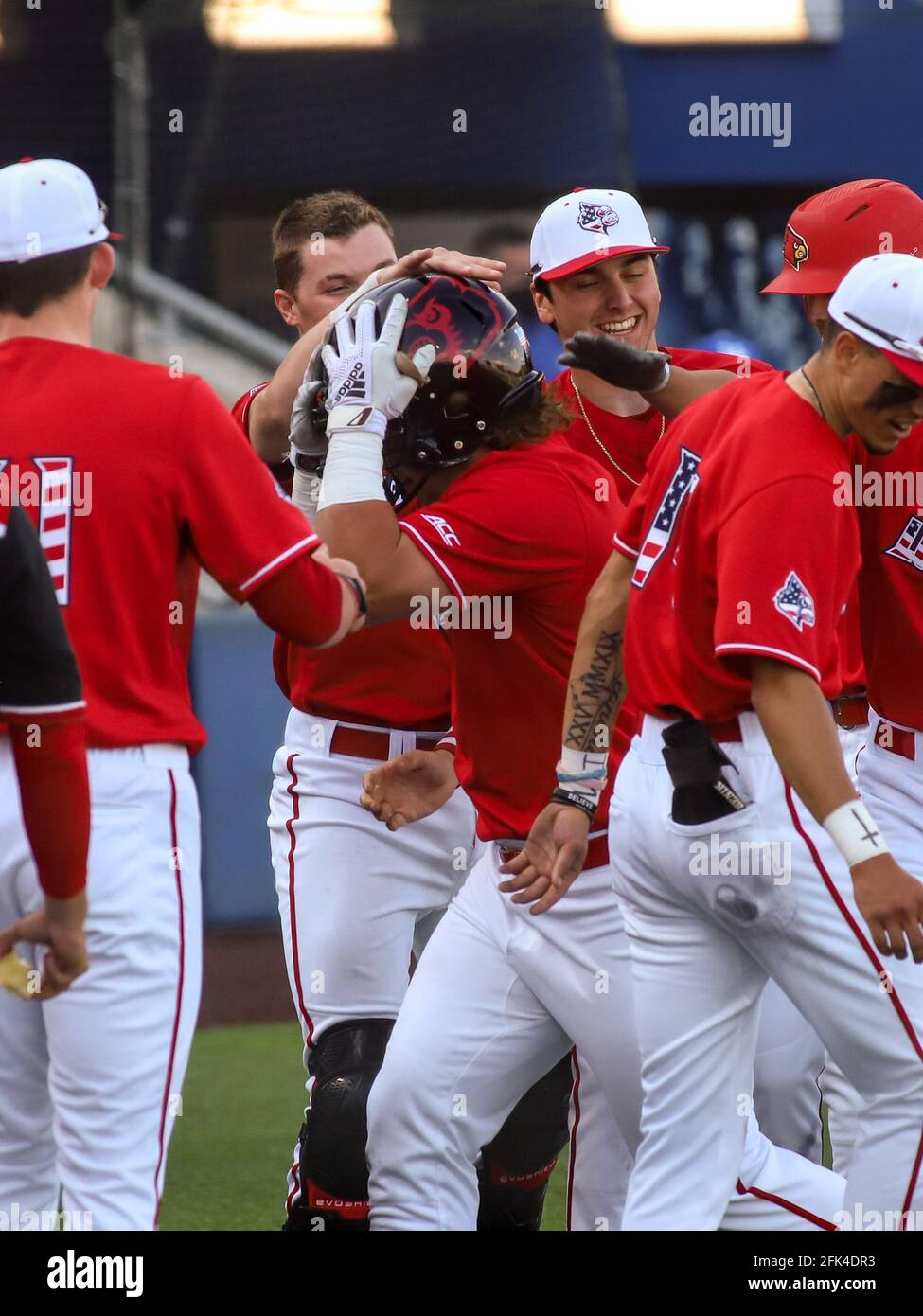 Lexington, KY, USA. 20th Apr, 2021. Louisville's Dalton Rushing celebrates his home run by dunning a football helmet during a game between the Kentucky Wildcats and the Louisville Cardinals at Kentucky Pride Park in Lexington, KY. Kevin Schultz/CSM/Alamy Live News Stock Photo