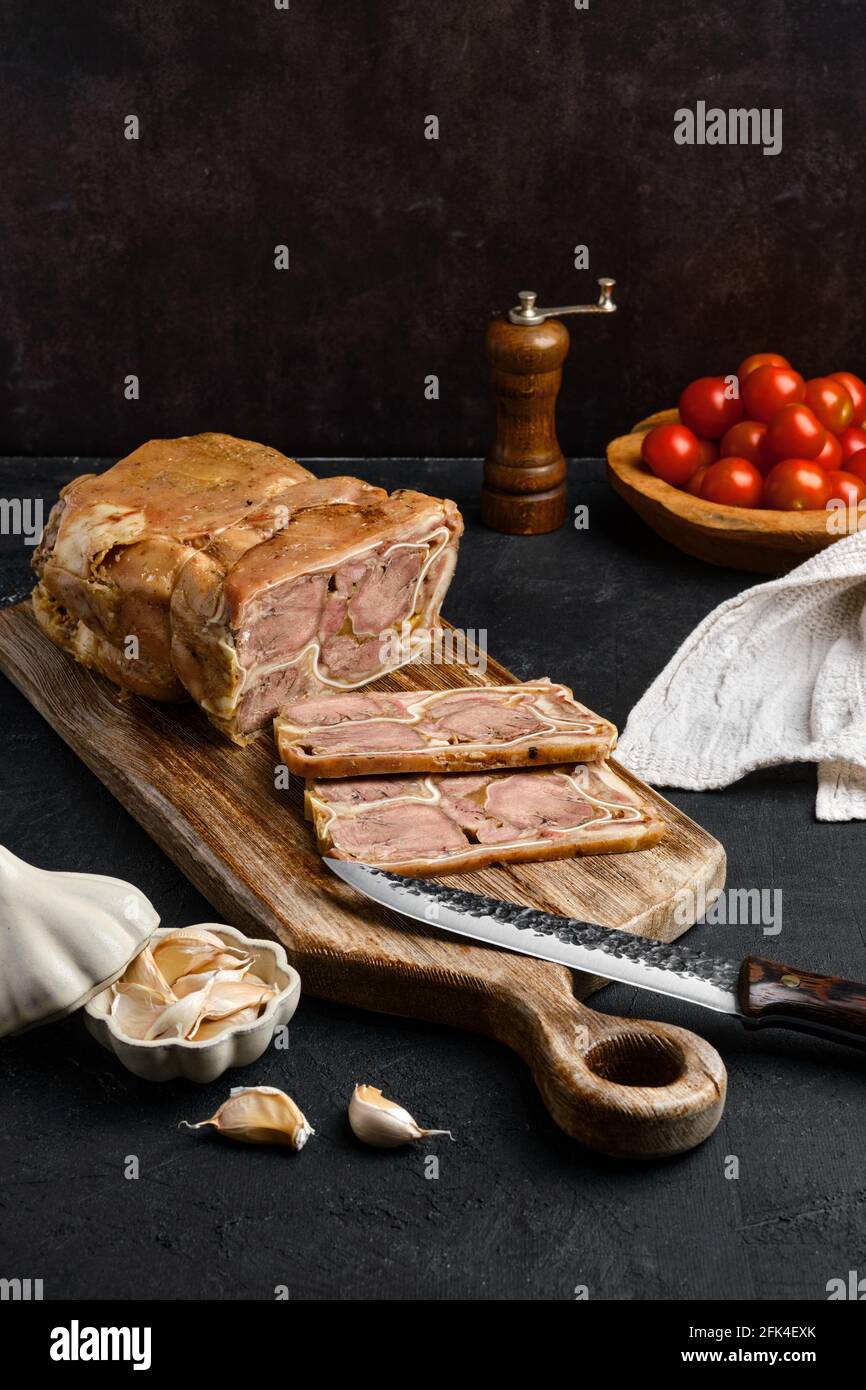 Boiled beef tongue roll on wooden cutting board Stock Photo