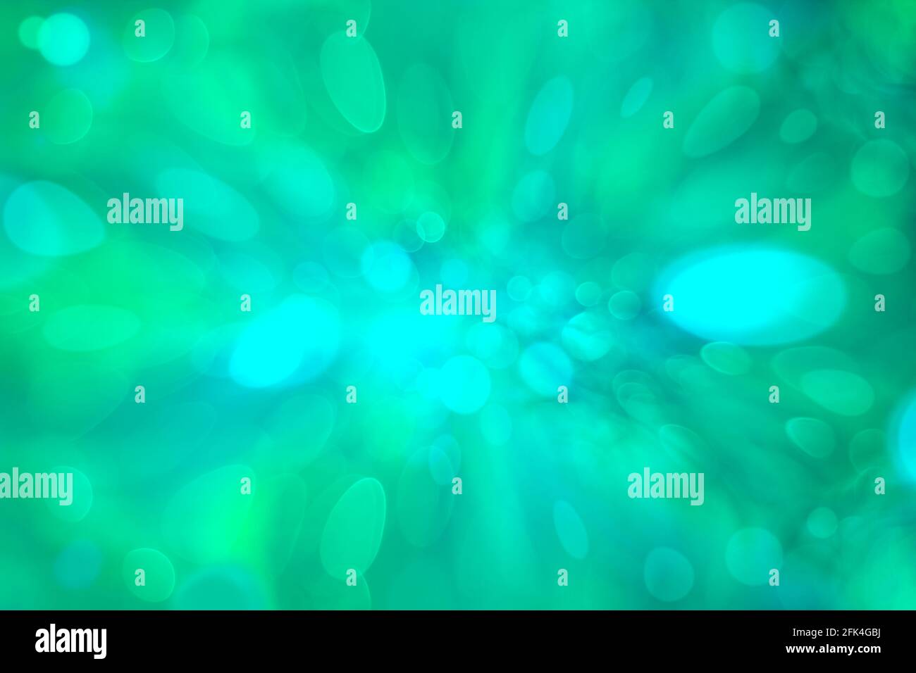 Color abstract circular backgrounds. Twinkling lights vivid blurred bokeh abstract in softness in green background. Zoom effect. Stock Photo