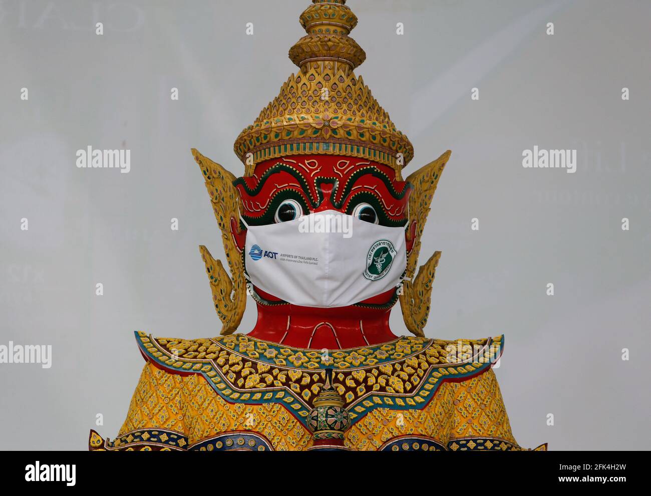 Bangkok, Thailand. 28th Apr, 2021. A giant statue wearing a face mask