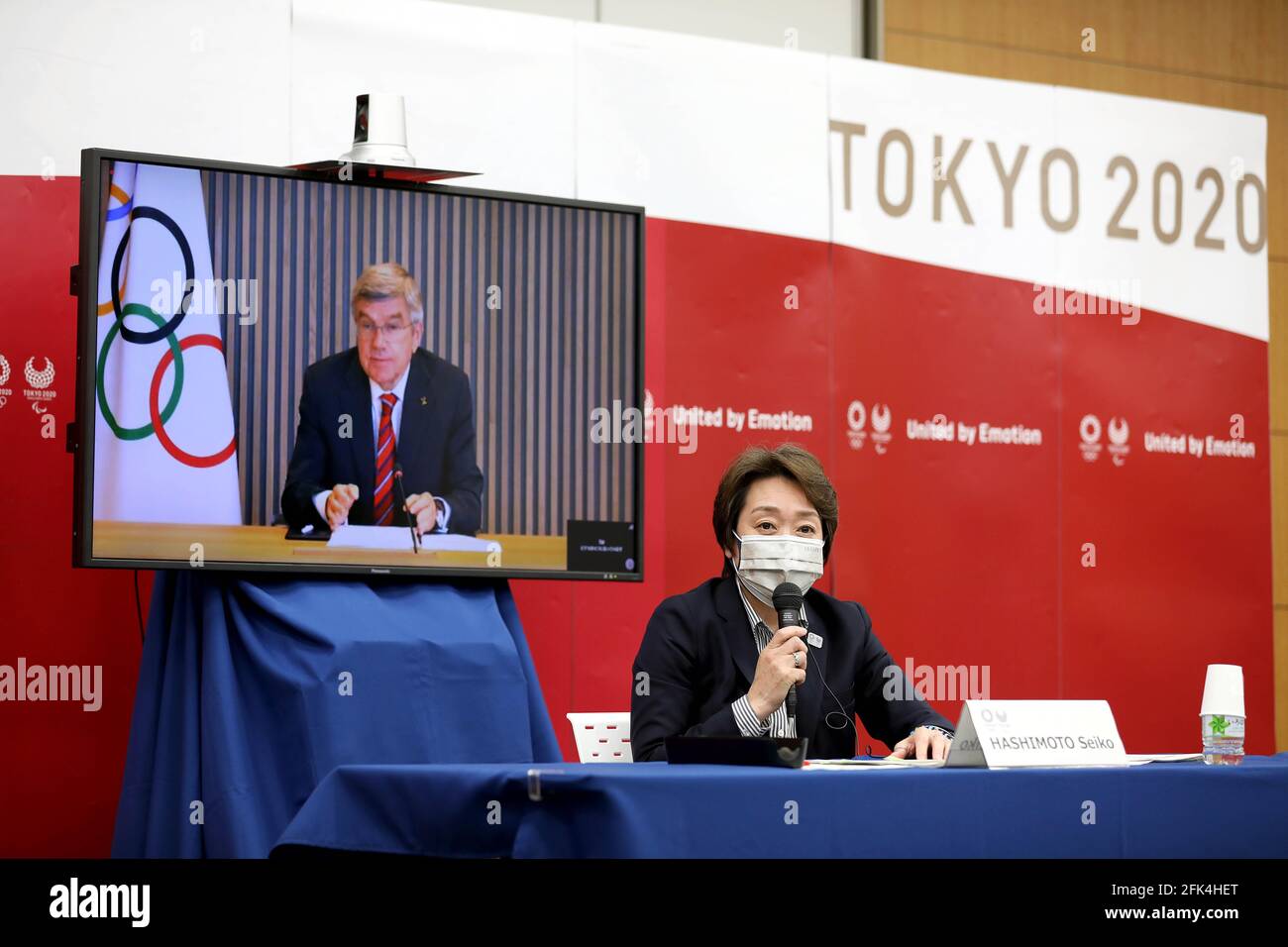 (210428) -- TOKYO, April 28, 2021 (Xinhua) -- Tokyo 2020 Organizing Committee president Seiko Hashimoto speaks as International Olympic Committee (IOC) president Thomas Bach (on a screen) listens during a five-party meeting of Tokyo 2020 Olympic and Paralympic Games in Tokyo, Japan, April 28, 2021. (Tokyo 2020/Handout via Xinhua) Stock Photo