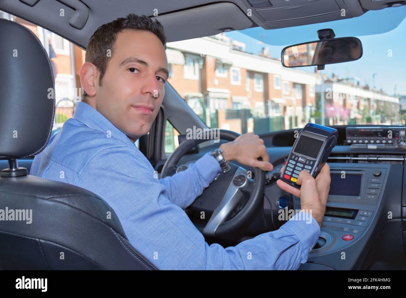 Taxi driver using a POS System to charge the customer with a credit card or wireless systems