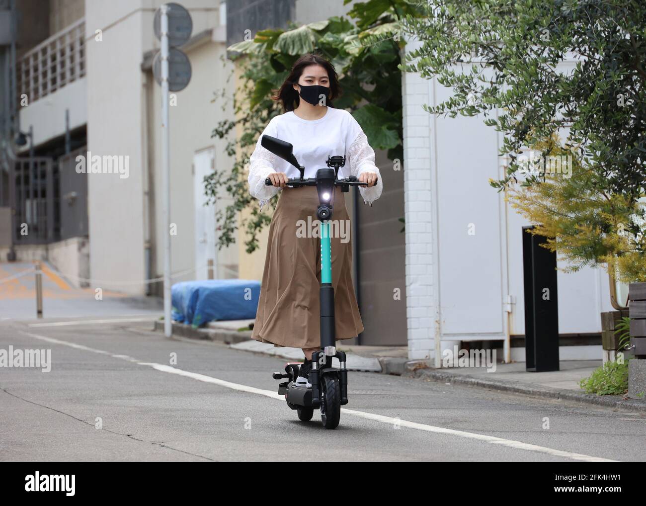 April 28, 2021, Tokyo, Japan An employee of Japan's micro mobility
