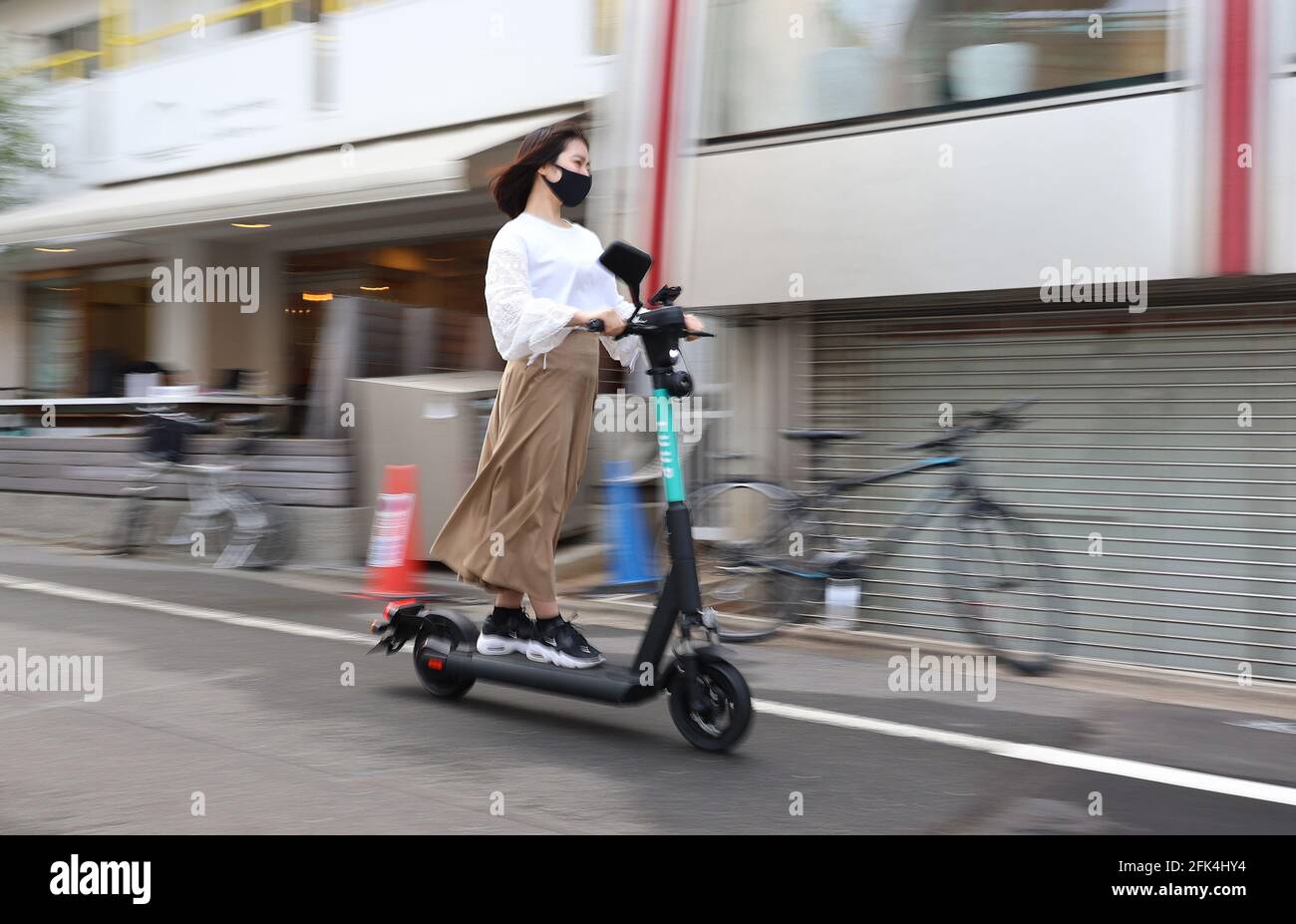 April 28, 2021, Tokyo, Japan An employee of Japan's micro mobility