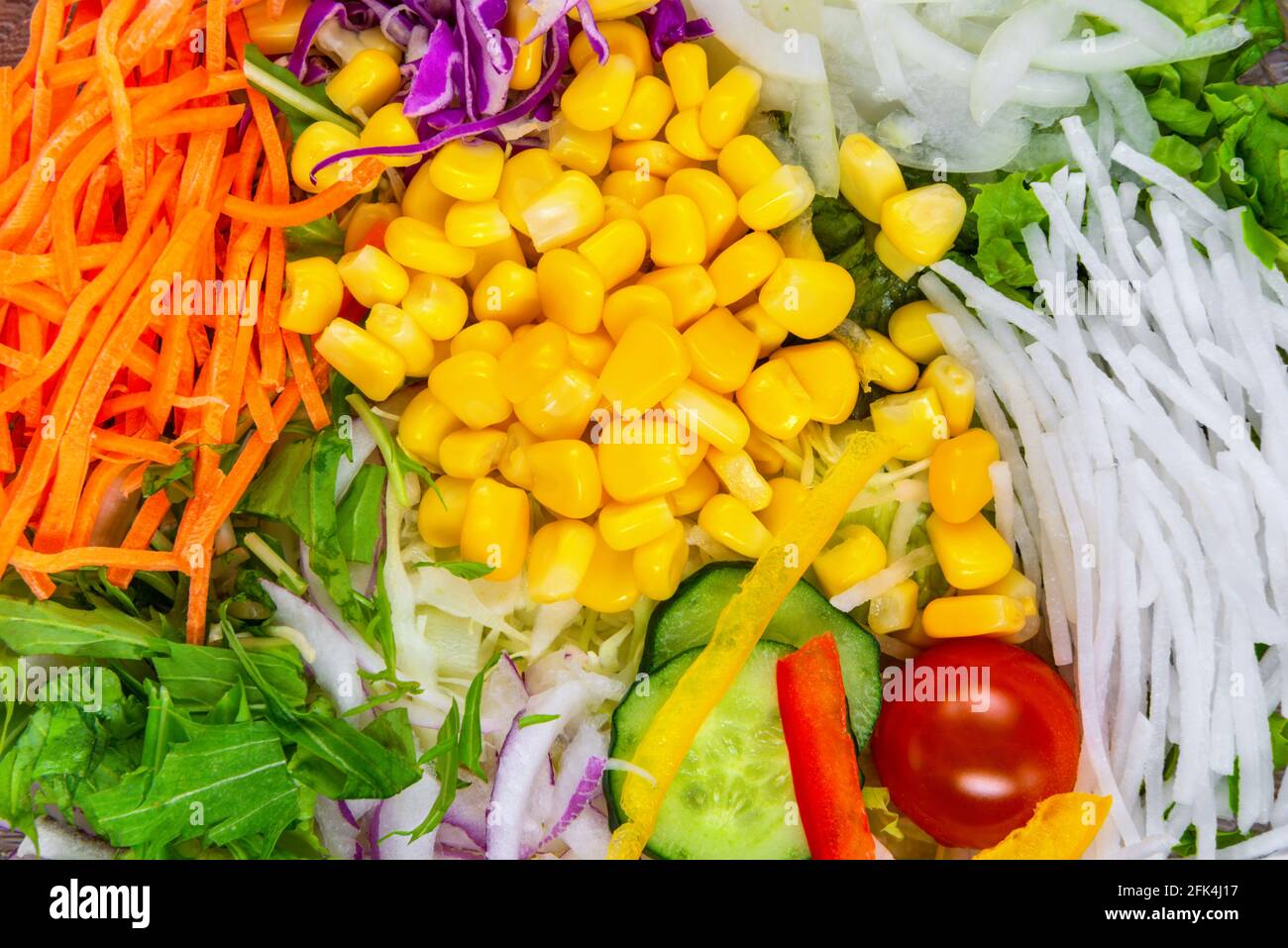 flat lay of mix stripes carrots, radish, onion, tomato, cabbage, cucumber and corn vegetables for salad, concept healthy eating Stock Photo