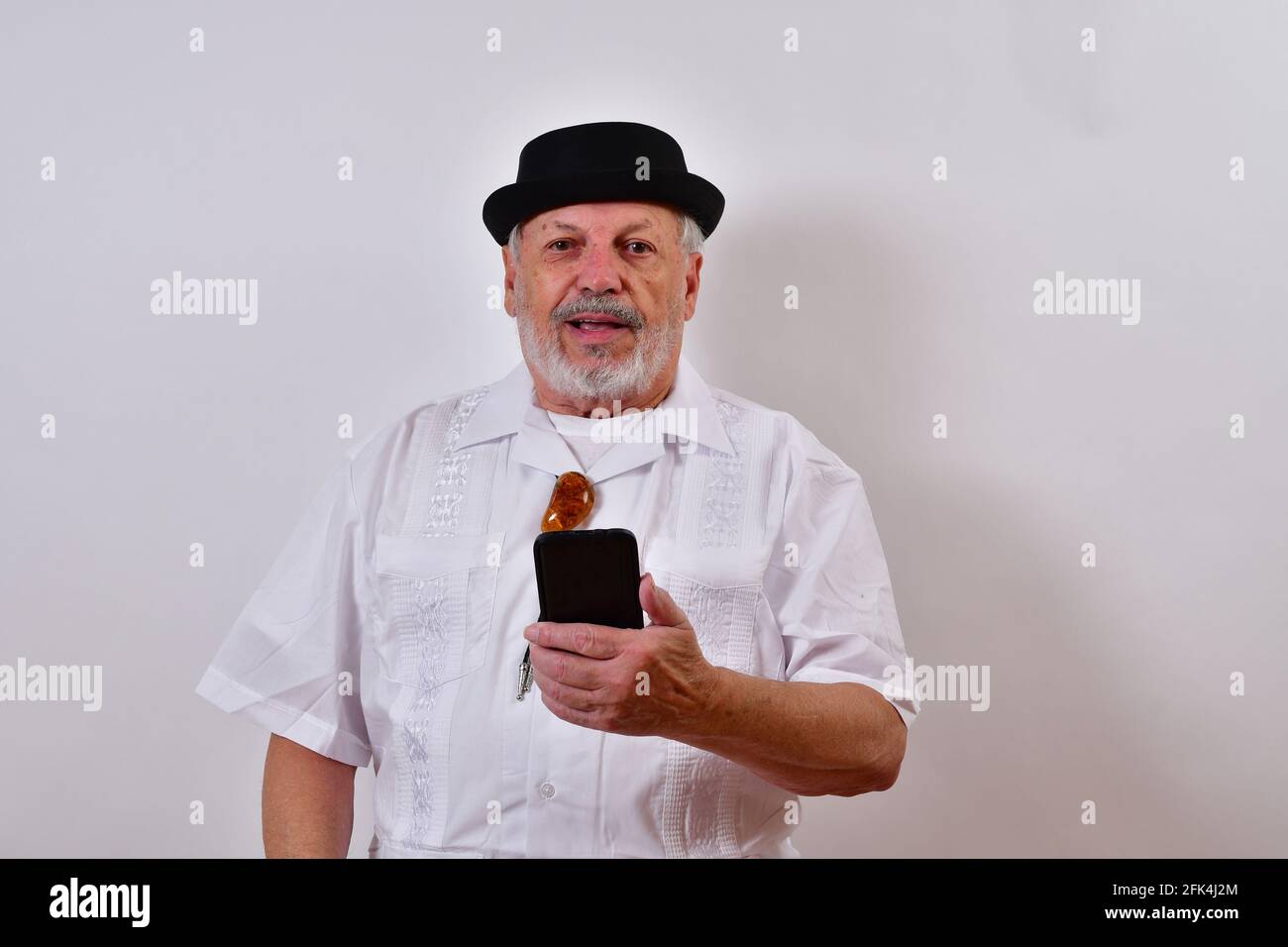 Senior man using his smartphone and smiling Stock Photo