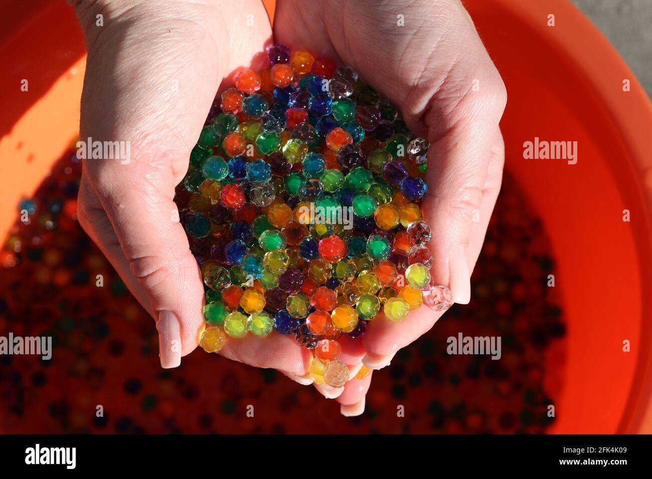 Small colorful plastic balls in the hands Stock Photo Alamy