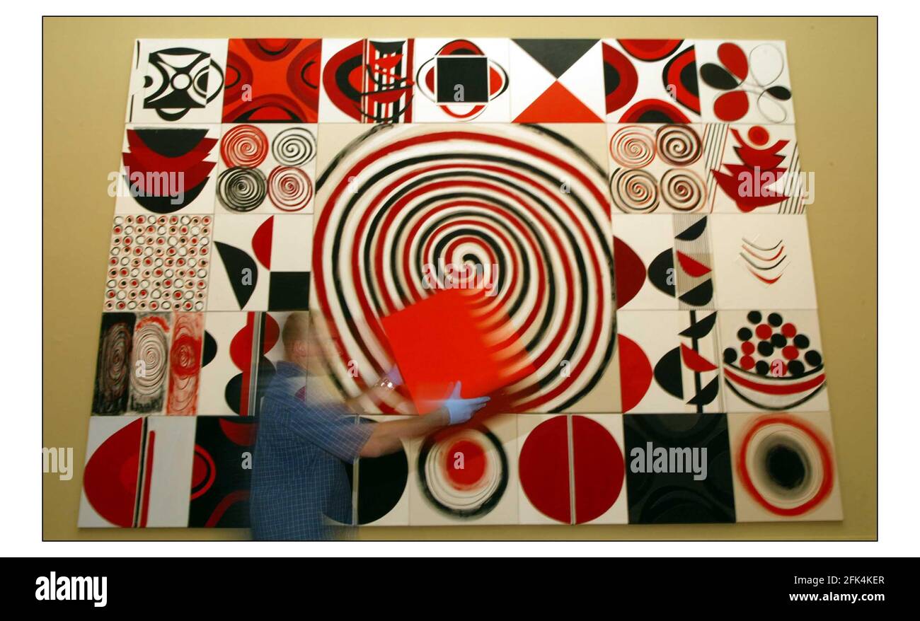 A spectacular wall of black, white and red abstract designs by the late Terry Frost being puy into placefor this years Summer  Exhibition. Called INSTALLATION Stock Photo