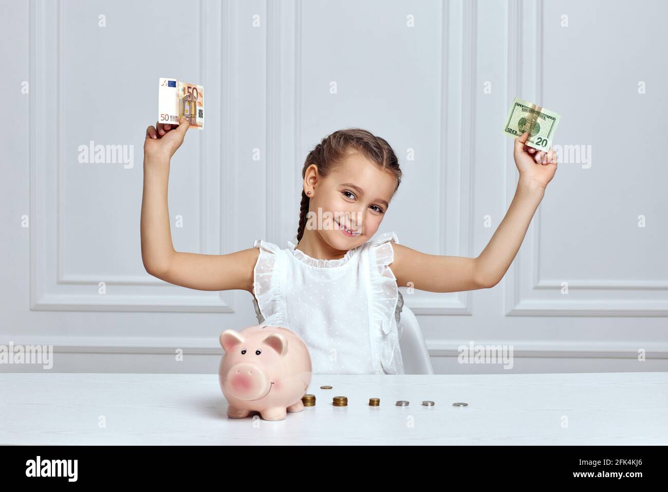 Little child girl with piggy bank at home Stock Photo - Alamy