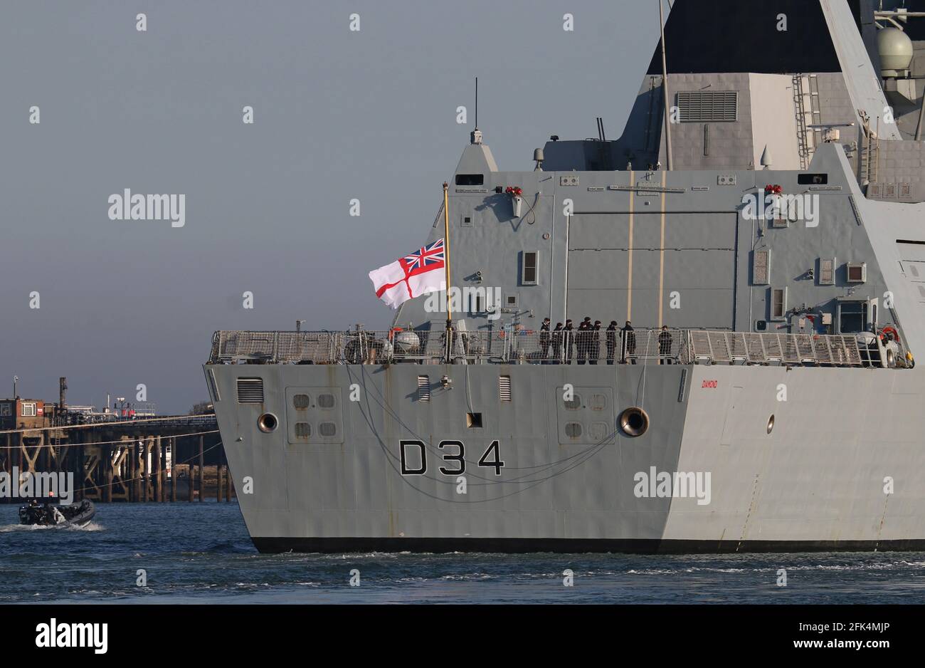 The white ensign on the Royal Navy ship HMS DIAMOND flies at half mast marking the official period of mourning for Prince Philip, Duke of Edinburgh Stock Photo