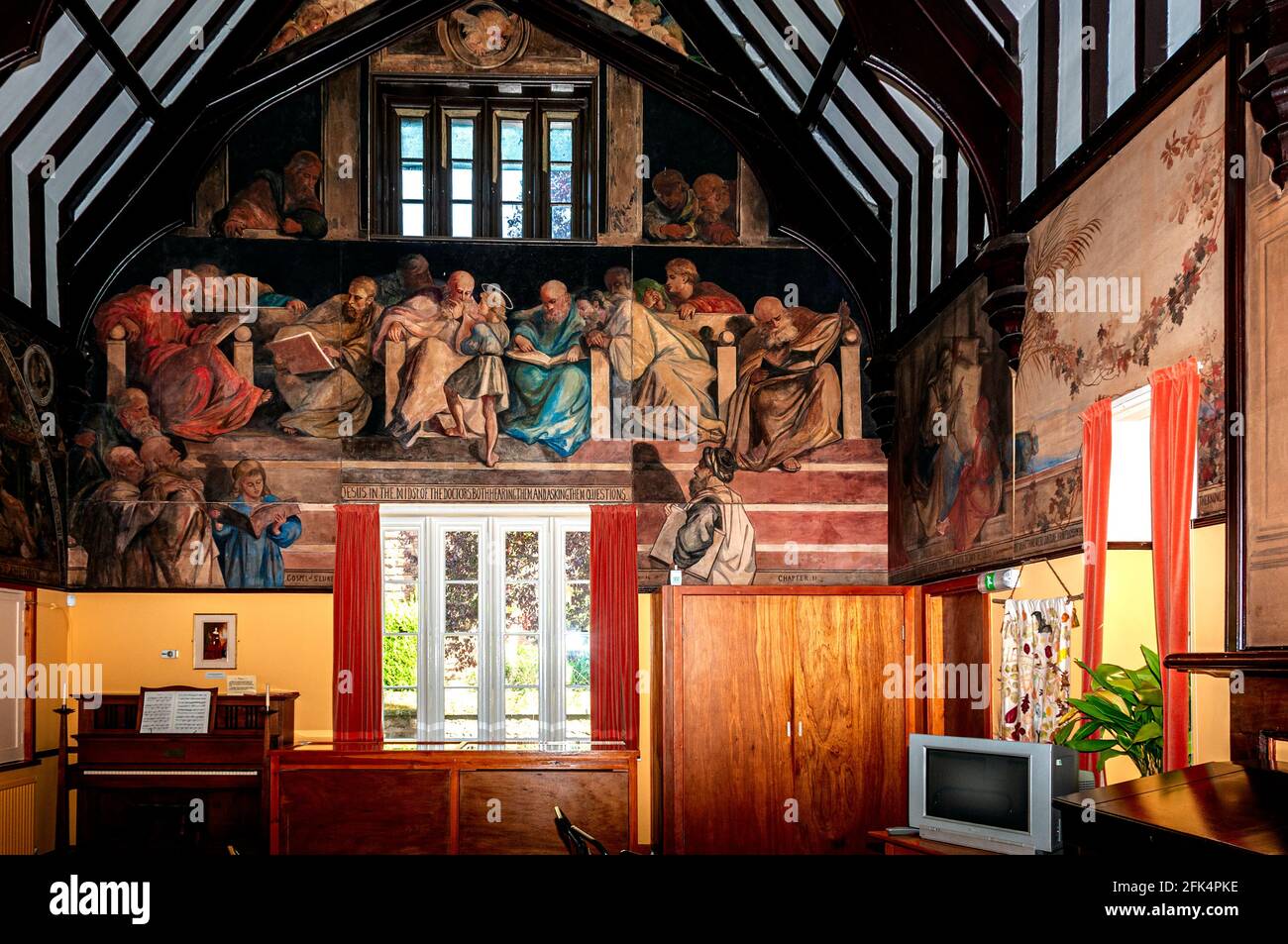 The main hall of a former village school built for the Marchioness of Waterford in 1860 and decorated with a series of paintings by the Marchioness Stock Photo