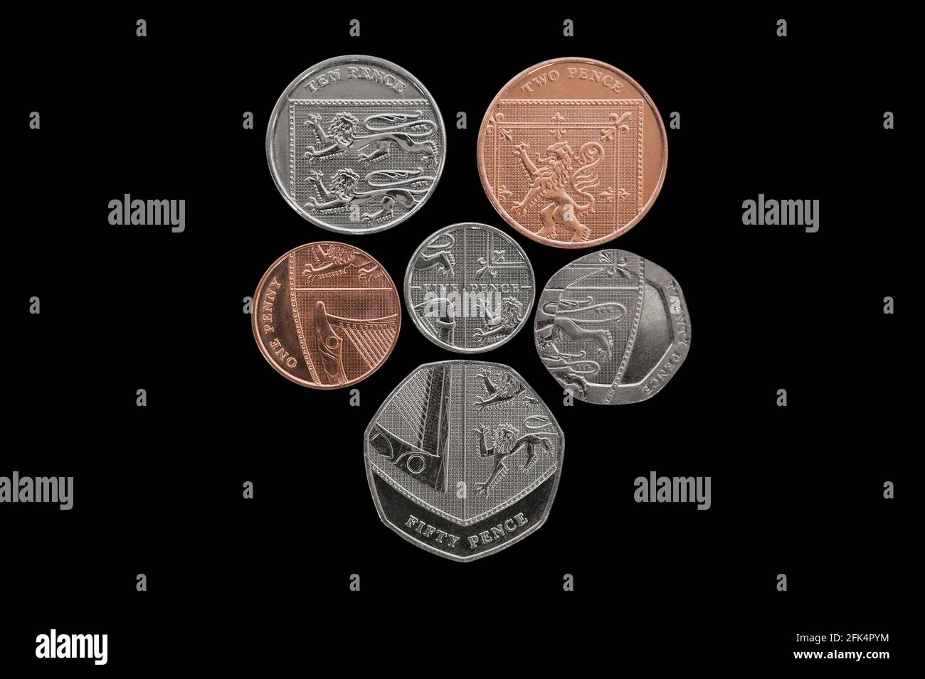 Queen's Coat of Arms Shield BRITISH STERLING COINS currency, designed by award winning Mathew Dent  - Black Background Stock Photo