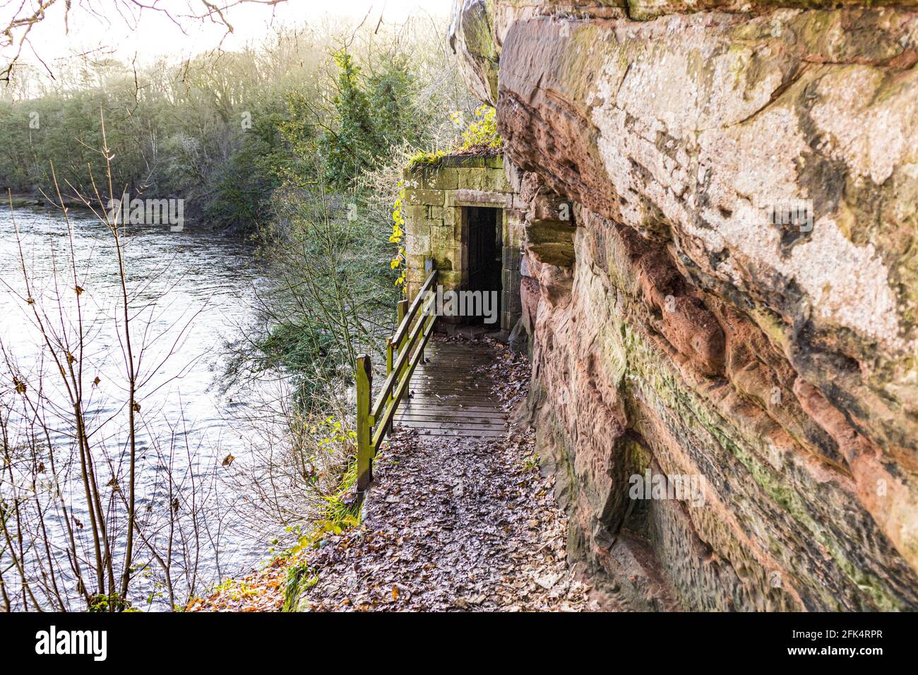 The entrance to St Constantines Cells - three medieval cave dwellings cut into the cliff above the River Eden at Wetheral, Cumbria UK Stock Photo