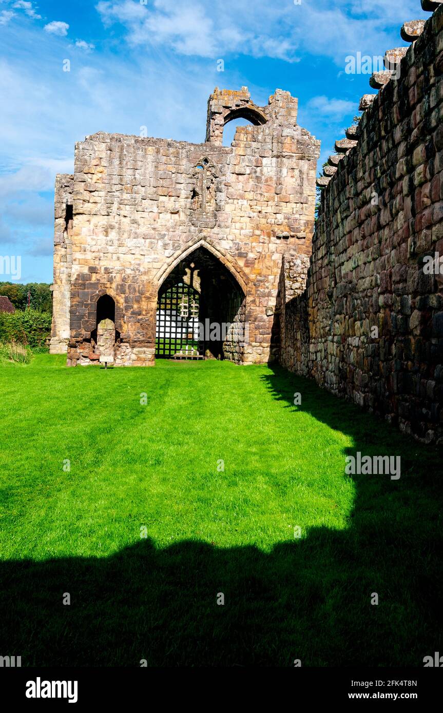 The ruins of the once formidable looking two-storey 14th century gatehouse comprising a portcullis, vaulted gate passage, and two towers at the front Stock Photo