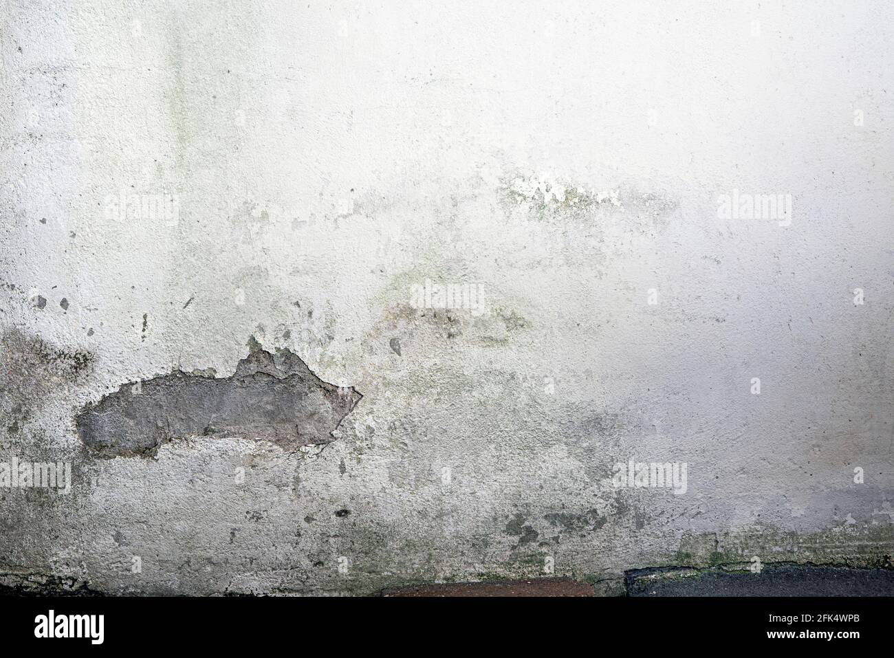 Structure of dirty white wall with dilapidated plaster. Rough white