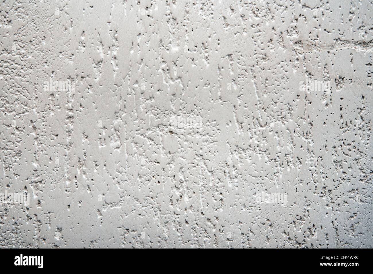 Structure of dirty white wall with dilapidated plaster. Rough white