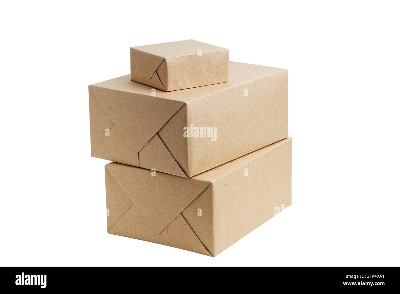 Closed brown cardboard boxes wrapped in kraft paper without label. Box for parcel, delivery or packaging isolated on white background. Stock Photo