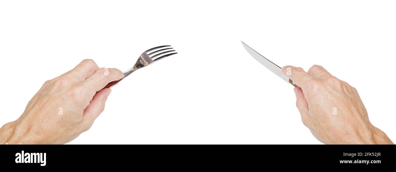 Humans hands holding a silver fork and knife isolated on white. Concept