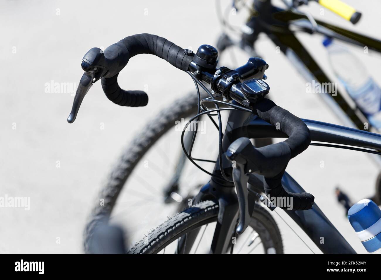 Closeup bicycle rudder with brake handles and trip computer against blurred background Stock Photo