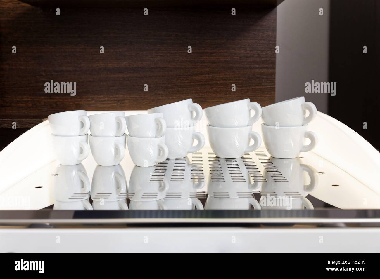 Clean white coffee cups for espresso and cappuccino stand on top of the