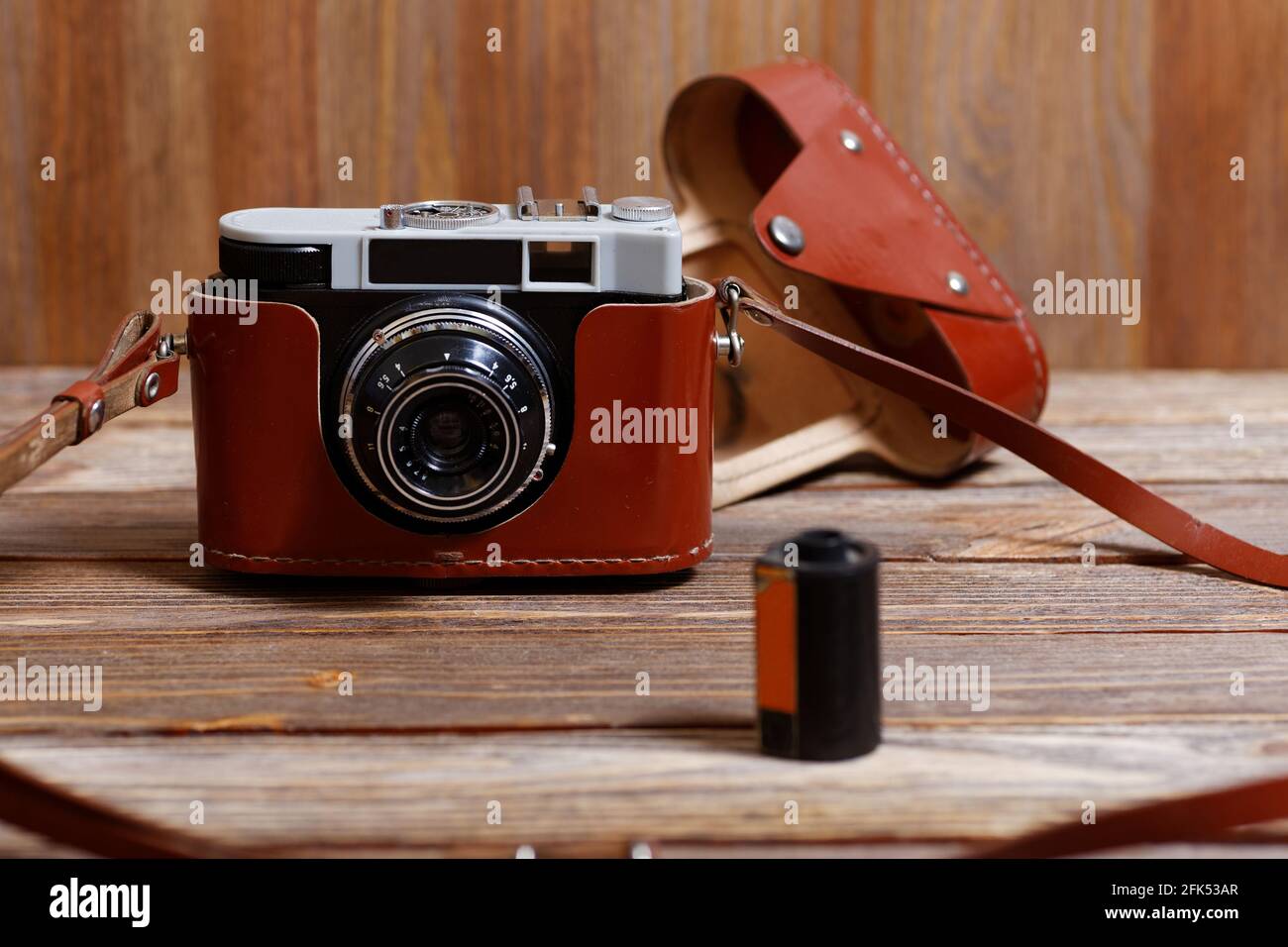 Old vintage retro photo camera on wooden background Stock Photo