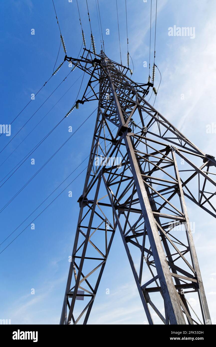 Electricity transmission pylon on a background of blue sky Stock Photo
