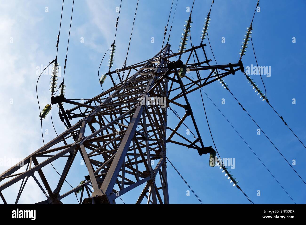 High voltage tower. Electricity transmission pylon on a background of blue sky Stock Photo