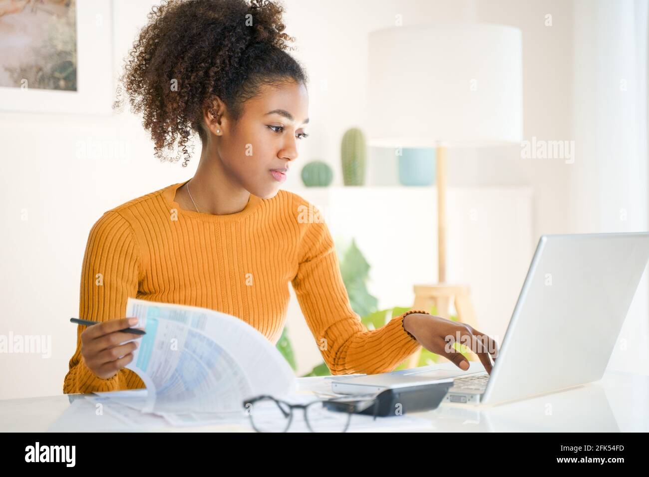 Distance studying, e-learning .Woman using laptop computer at home, study online Stock Photo