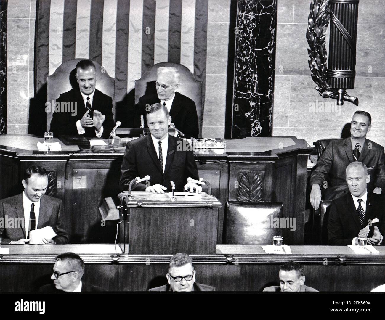 Washington, DC - (FILE) -- Astronaut Neil Armstrong displays his boyish grim as he shares the rostrum in the United States House of Representatives with fellow lunar travelers Michael Collins, left, and Edwin E. 'Buzz' Aldrin, Jr., right, as they address a Joint Session of Congress on September 16, 1969. Armstrong's remarks enjoyed the applause of Vice President Spiro Agnew, left rear, and Speaker of the House John McCormick (Democrat of Massachusetts), rear right.Credit: Arnie Sachs/CNP /MediaPunch Stock Photo