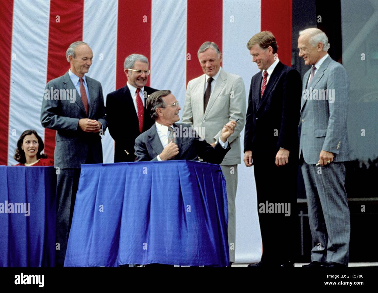 United States President George H.W. Bush signs a proclamation after announcing plans for the Space Exploration Initiative (SEI) on the the 20th anniversary of the Apollo 11 Moon landing at the National Air and Space Museum in Washington, DC on July 20, 1989. From left to right: Marilyn Quayle (seated); Apollo 11 Command Module pilot Michael Collins; NASA Administrator Richard H. Truly; President Bush; Apollo 11 Command pilot Neil A. Armstrong; U.S. Vice President Dan Quayle; and Apollo 11 Lunar Module pilot Edwin (Buzz) Aldrin.Credit: Robert Trippett/Pool via CNP | usage worldwide Stock Photo