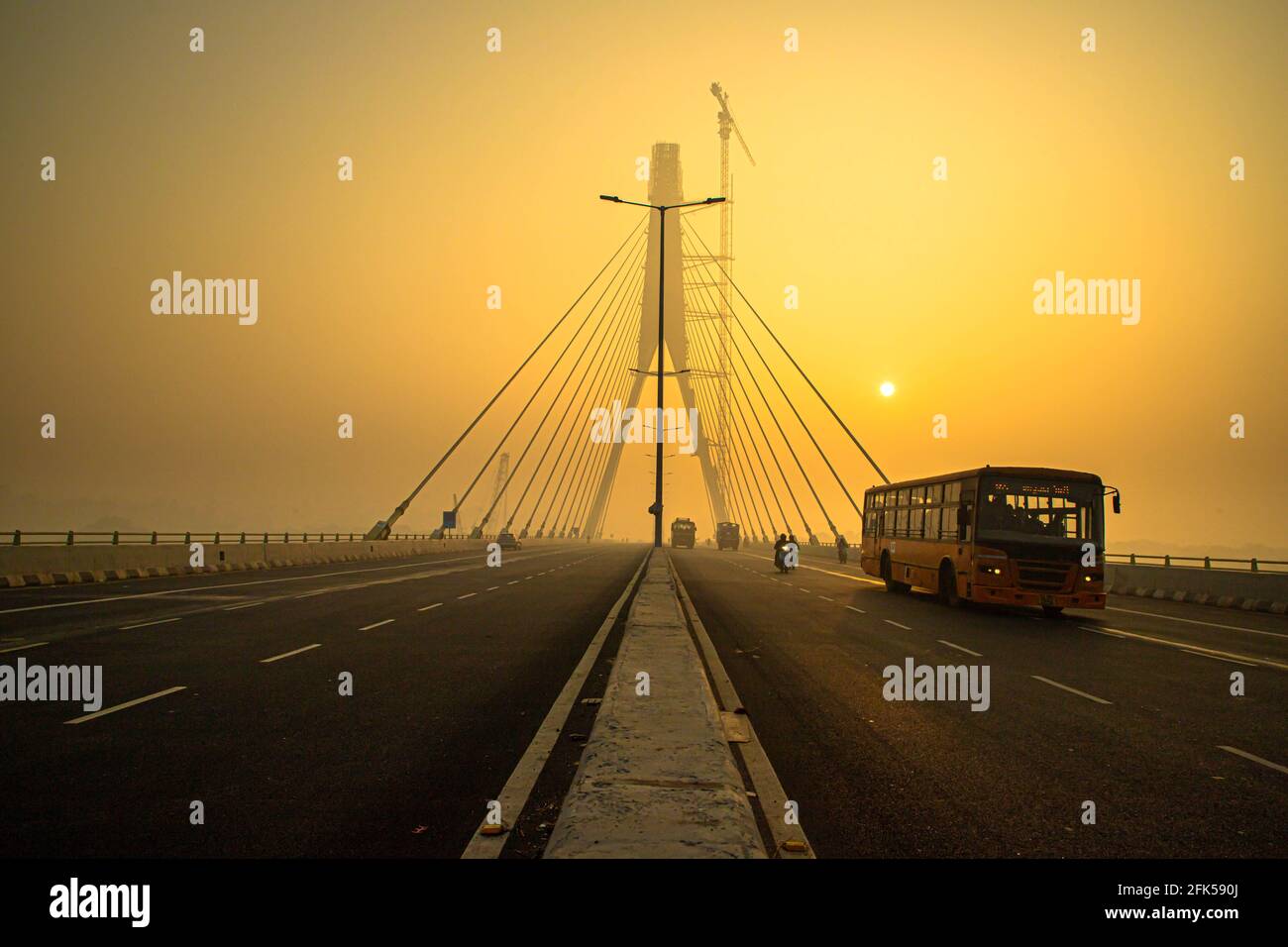 signature bridge is a cantilever spar cable stayed bridge which spans the yamuna river in delhi,with beautiful sun rise. Stock Photo