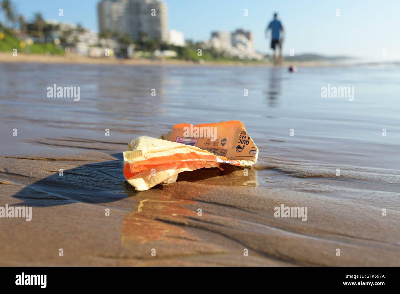 Plastic pollution, food packaging object on beautiful Umhlanga Rocks