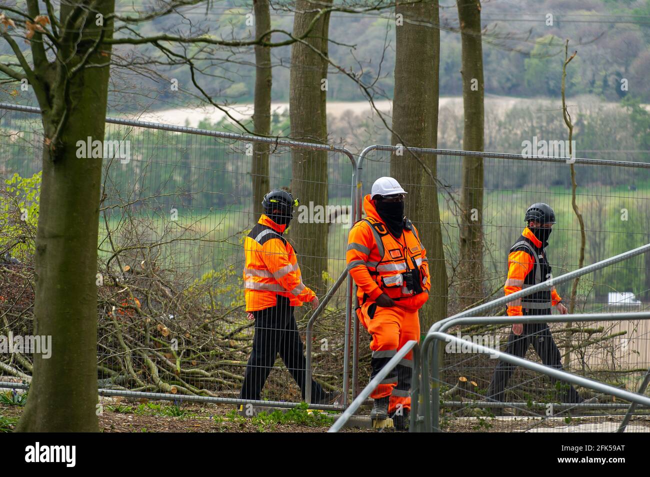 Aylesbury Vale, Buckinghamshire, UK. 27th April, 2021. Balaclava clad HS2 security in the woods. HS2 were back with their chainsaws again today in Jones Hill Wood. Following legal action taken against Natural England by Earth Protector Mark Kier HS2 were ordered to stop felling trees at Jones Hill Wood on 16th April 2021. HS2 have appealled and have now been given permission to start tree felling again despite it being the bird nesting season and that rare Barbastelle bats are known to roost in the woods.  The High Speed Rail 2 from London to Birmingham is carving a huge scar across Buckingham Stock Photo