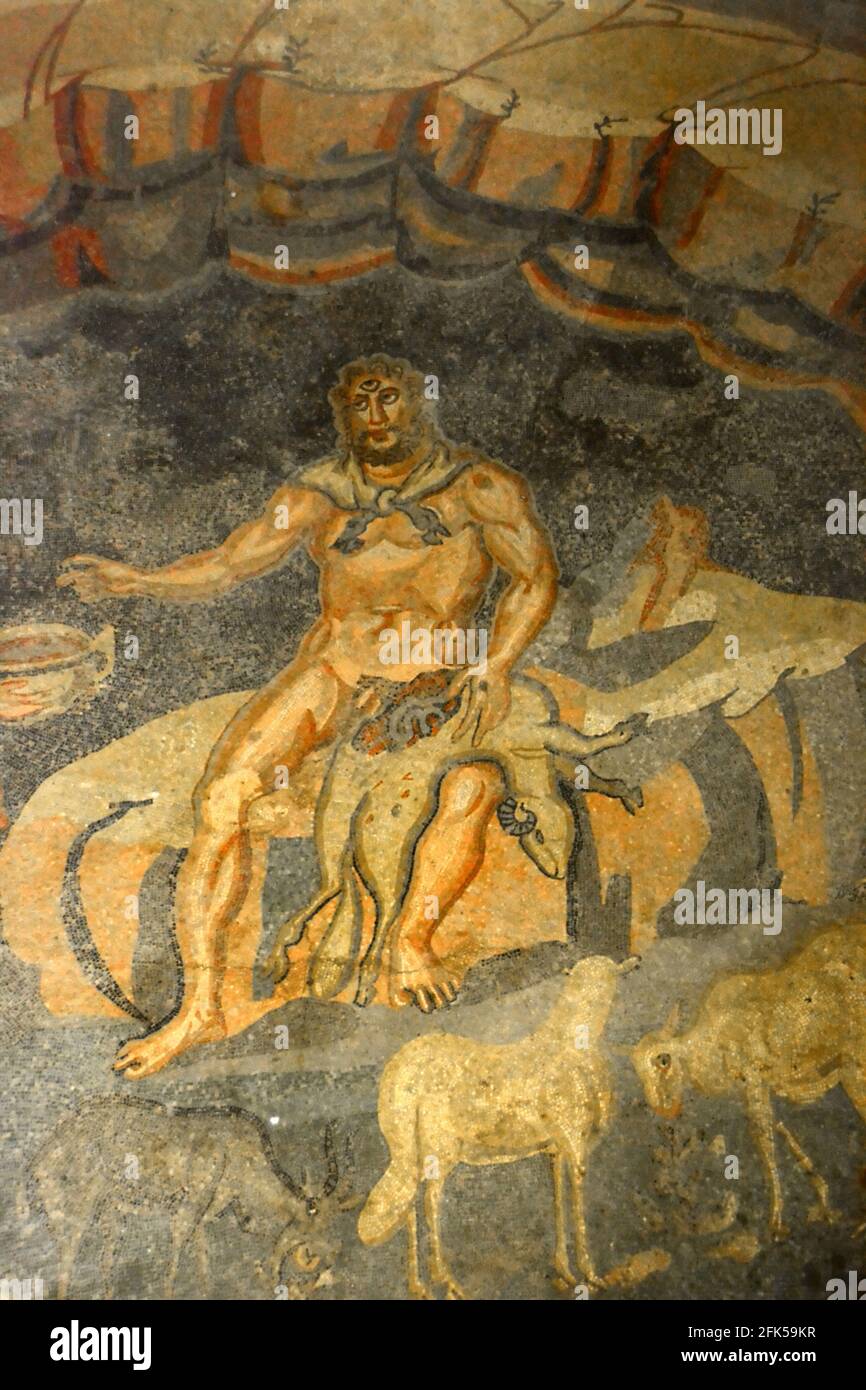 Ancient Roman mosaic of the Cyclops Giant Polyphemus in his cave with a dead sheep. From Book IX of the Odyssey. In the UNESCO listed Ancient Roman mo Stock Photo