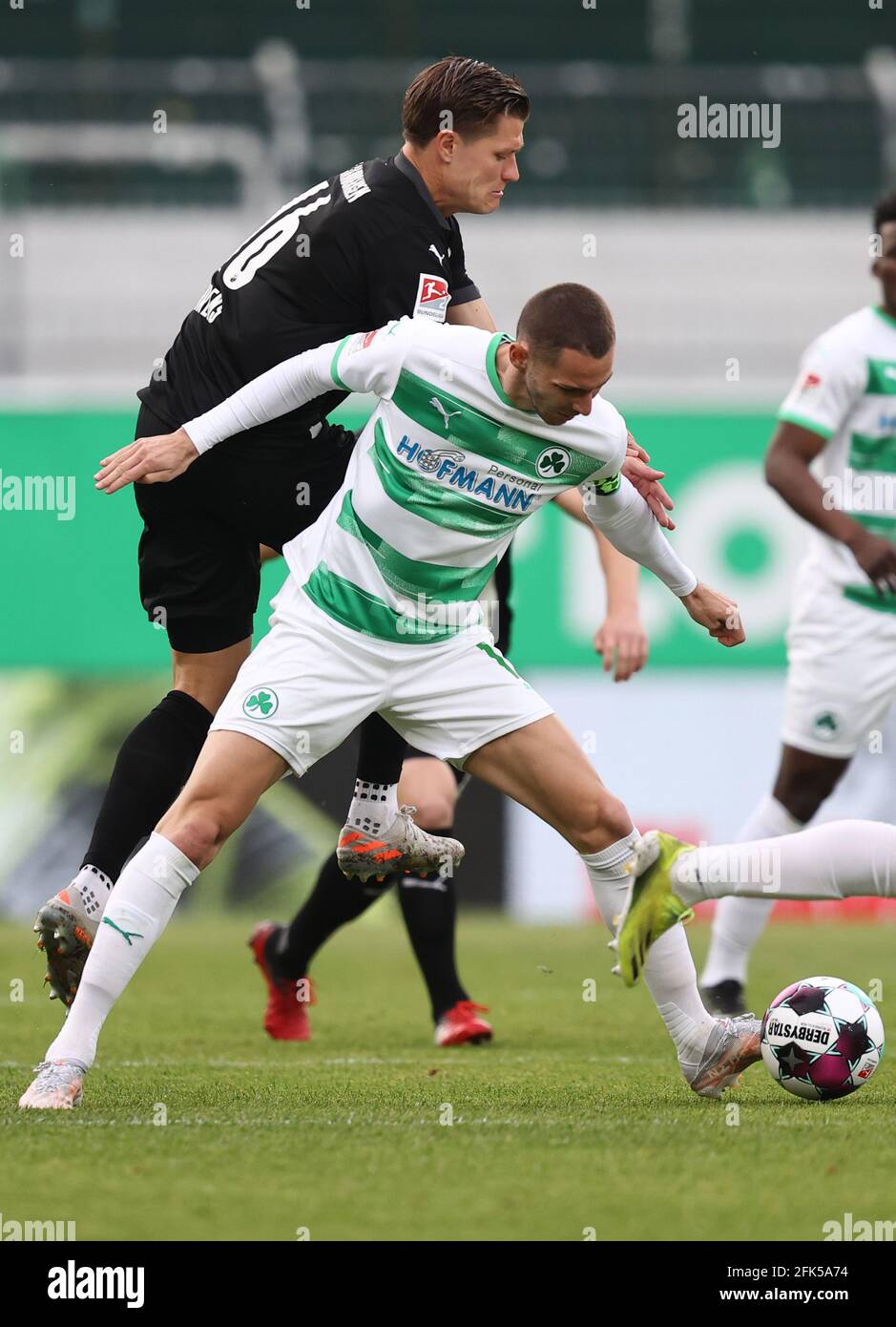28 April 2021, Bavaria, Fürth: Football: 2. Bundesliga, SpVgg Greuther Fürth - SV Sandhausen, Matchday 28, at Sportpark Ronhof Thomas Sommer. Fürth's Branimir Hrgota (centre) fights for the ball with SV Sandhausen's Kevin Behrens (left). Photo: Daniel Karmann/dpa - IMPORTANT NOTE: In accordance with the regulations of the DFL Deutsche Fußball Liga and/or the DFB Deutscher Fußball-Bund, it is prohibited to use or have used photographs taken in the stadium and/or of the match in the form of sequence pictures and/or video-like photo series. Stock Photo