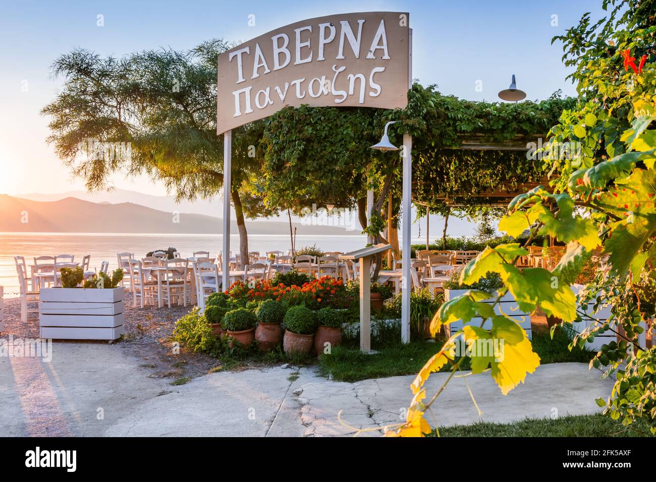 Lefkada, Greece - July 21, 2020: Nikiana beach taverna at sunrise, Lefkada island, Greece. Stock Photo