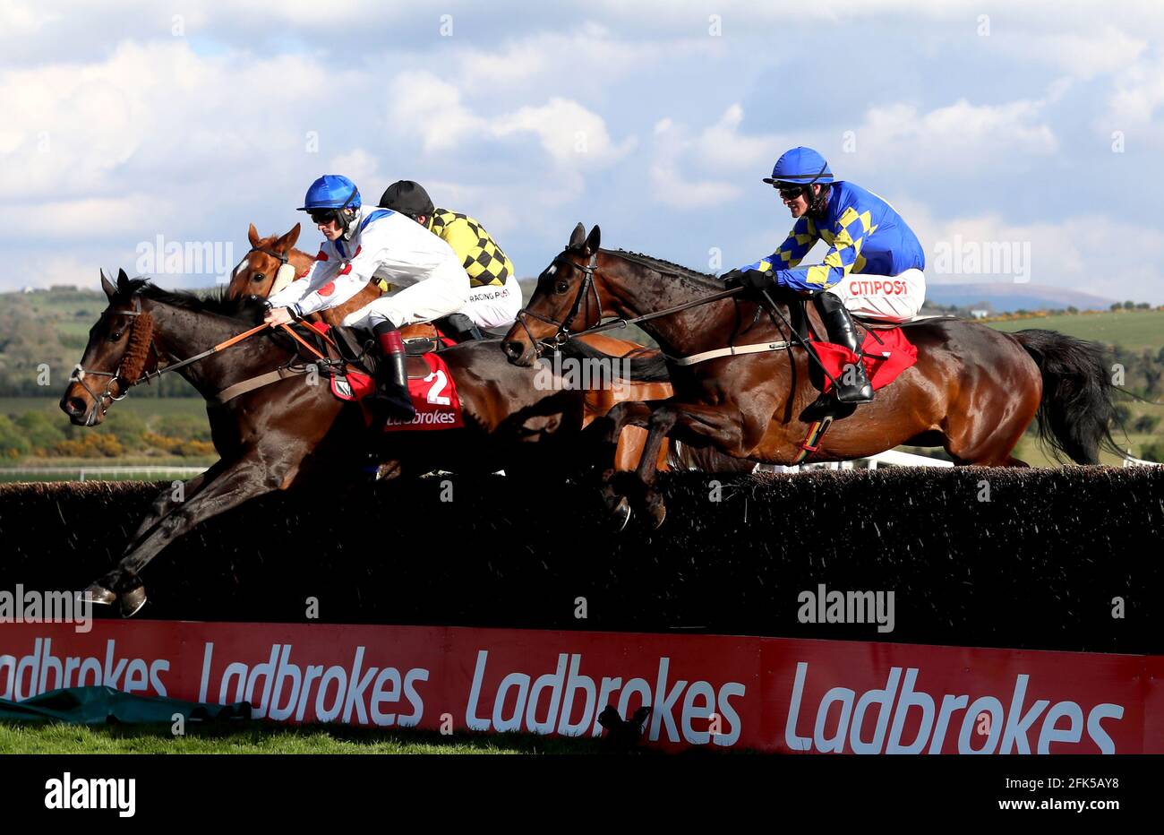 Clan Des Obeaux ridden by Sam Twiston-Davies (left) goes on to win The Ladbrokes Punchestown Gold Cup during day two of the Punchestown Festival at Punchestown Racecourse in County Kildare, Ireland. Issue date: Wednesday April 28, 2021. Stock Photo