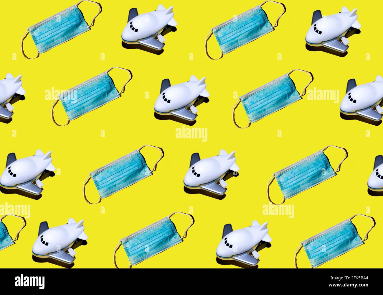 Pattern of airplanes and face masks on yellow background. Traveling on