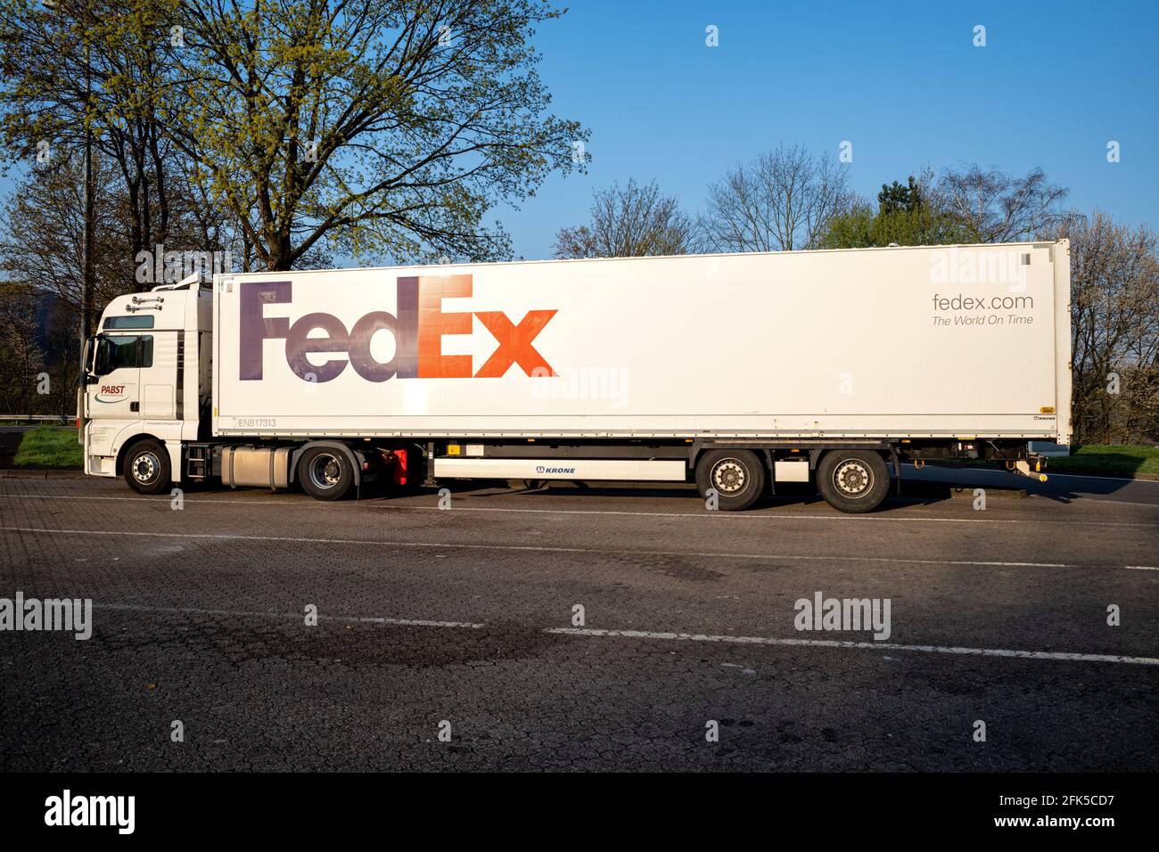 Pabst MAN TGX truck with FedEx trailer at motorway rest area. Stock Photo