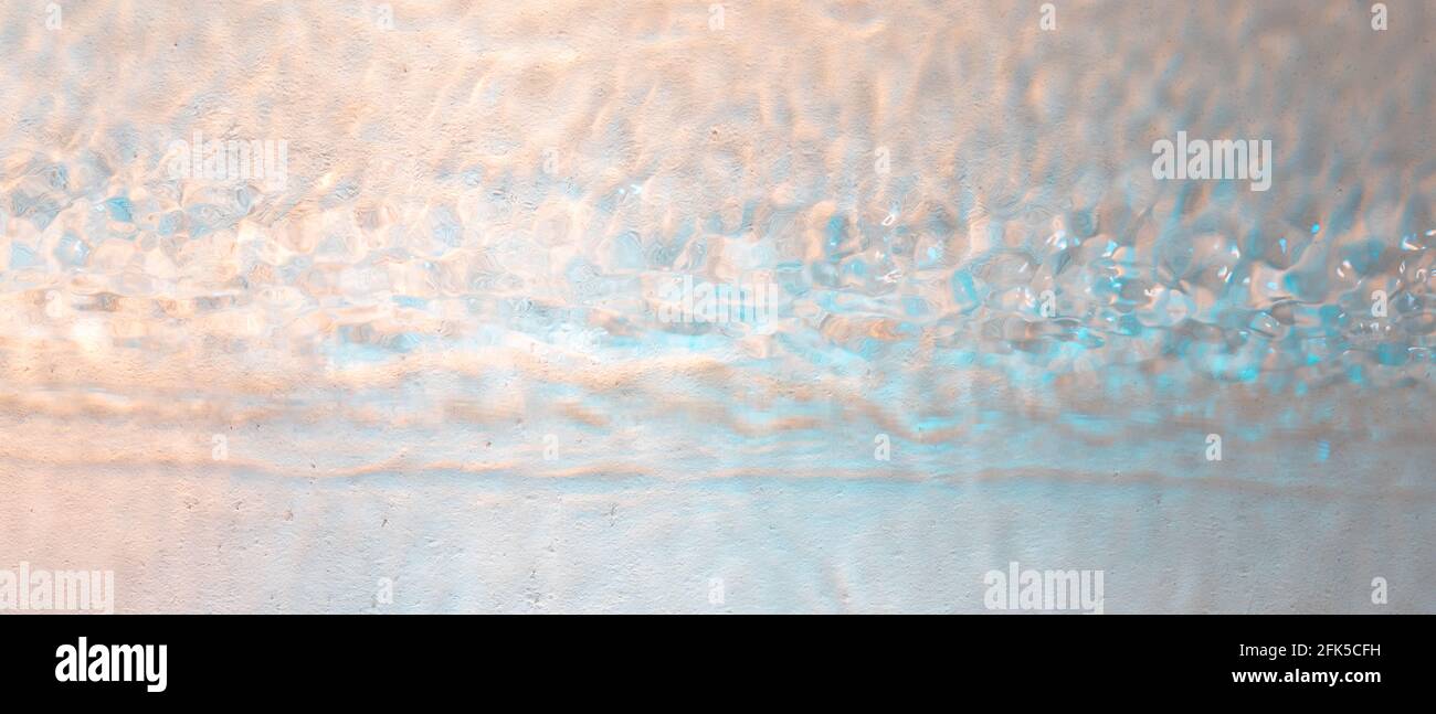 Wavy with rainbow colors abstract rippled water texture background Stock Photo