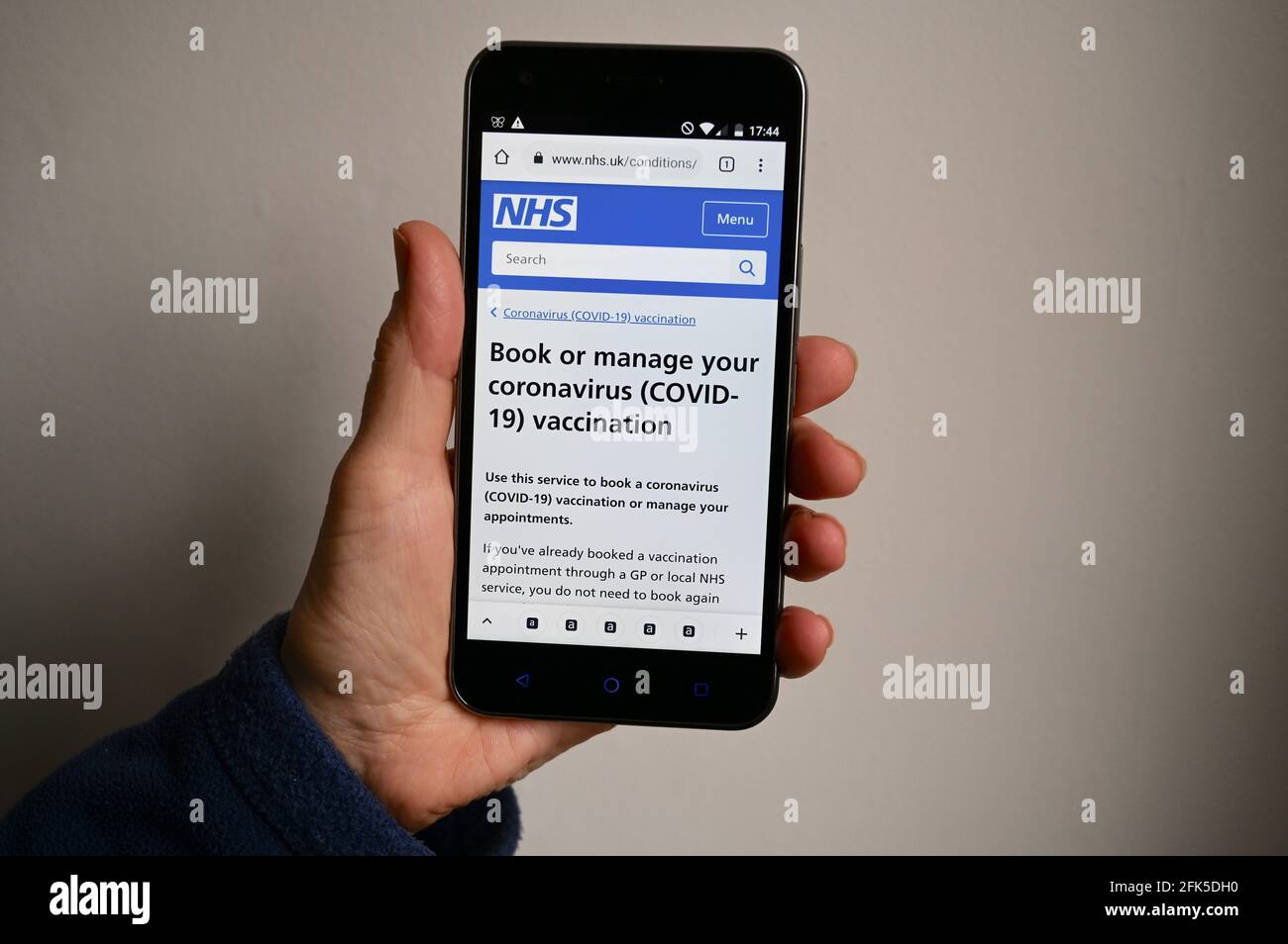 Coronavirus (COVID-19) vaccination NHS Website shown on a mobile phone screen. Stock Photo