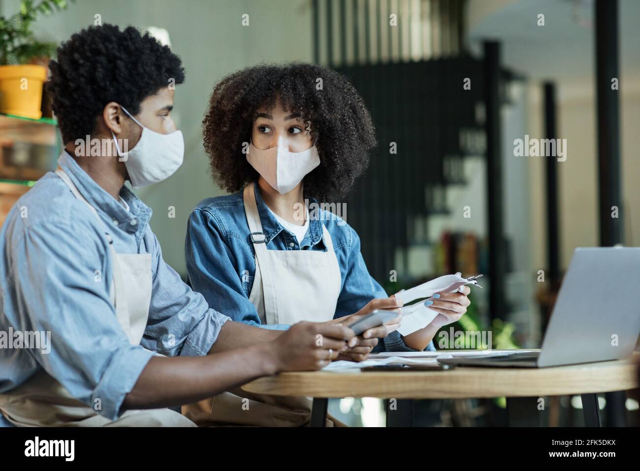 Owners of small family businesses do bookkeeping and taxes, have problems with loans in time for coronavirus Stock Photo