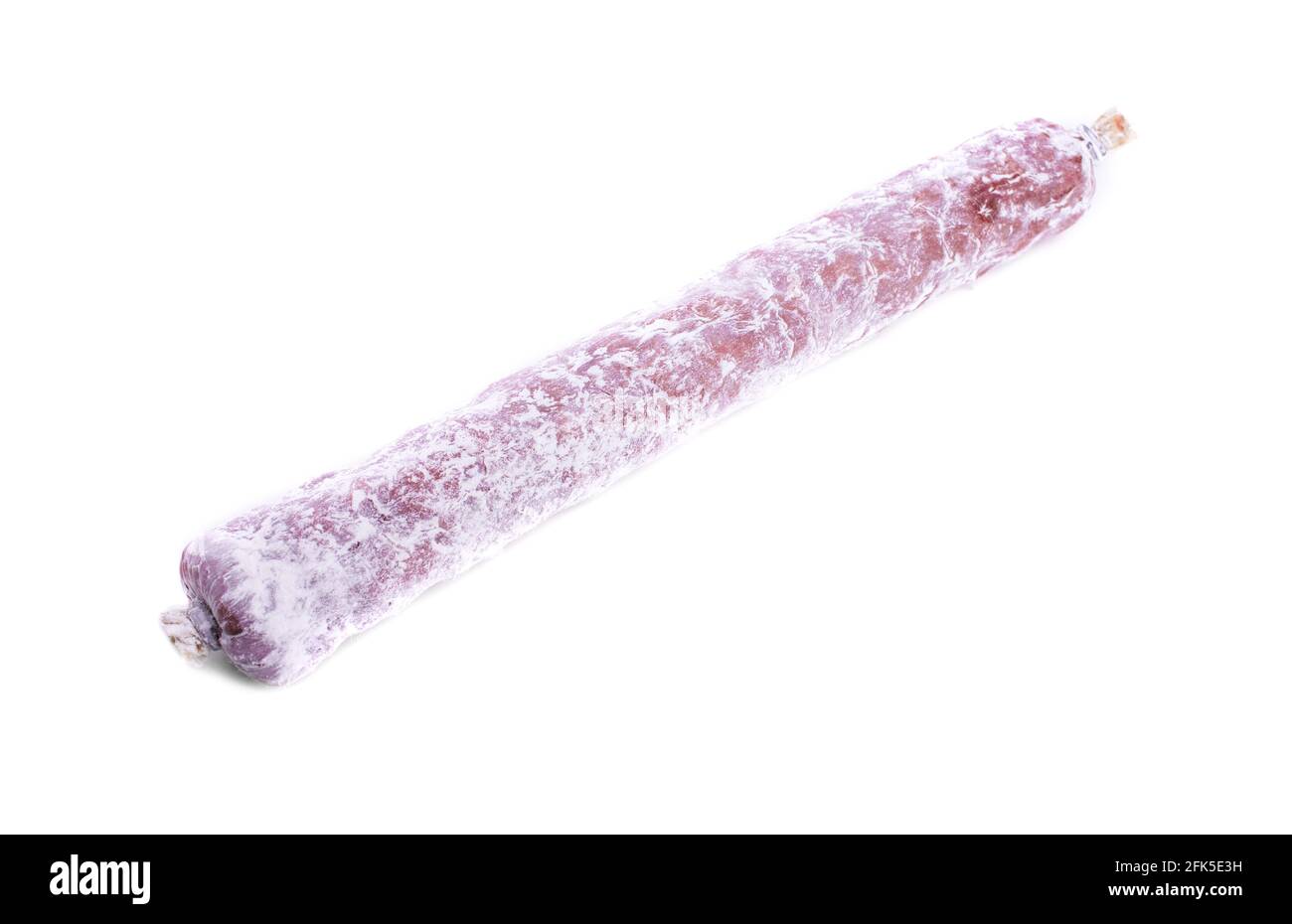 Delicious italian felino salami stick. Isolated on a white background. Stock Photo