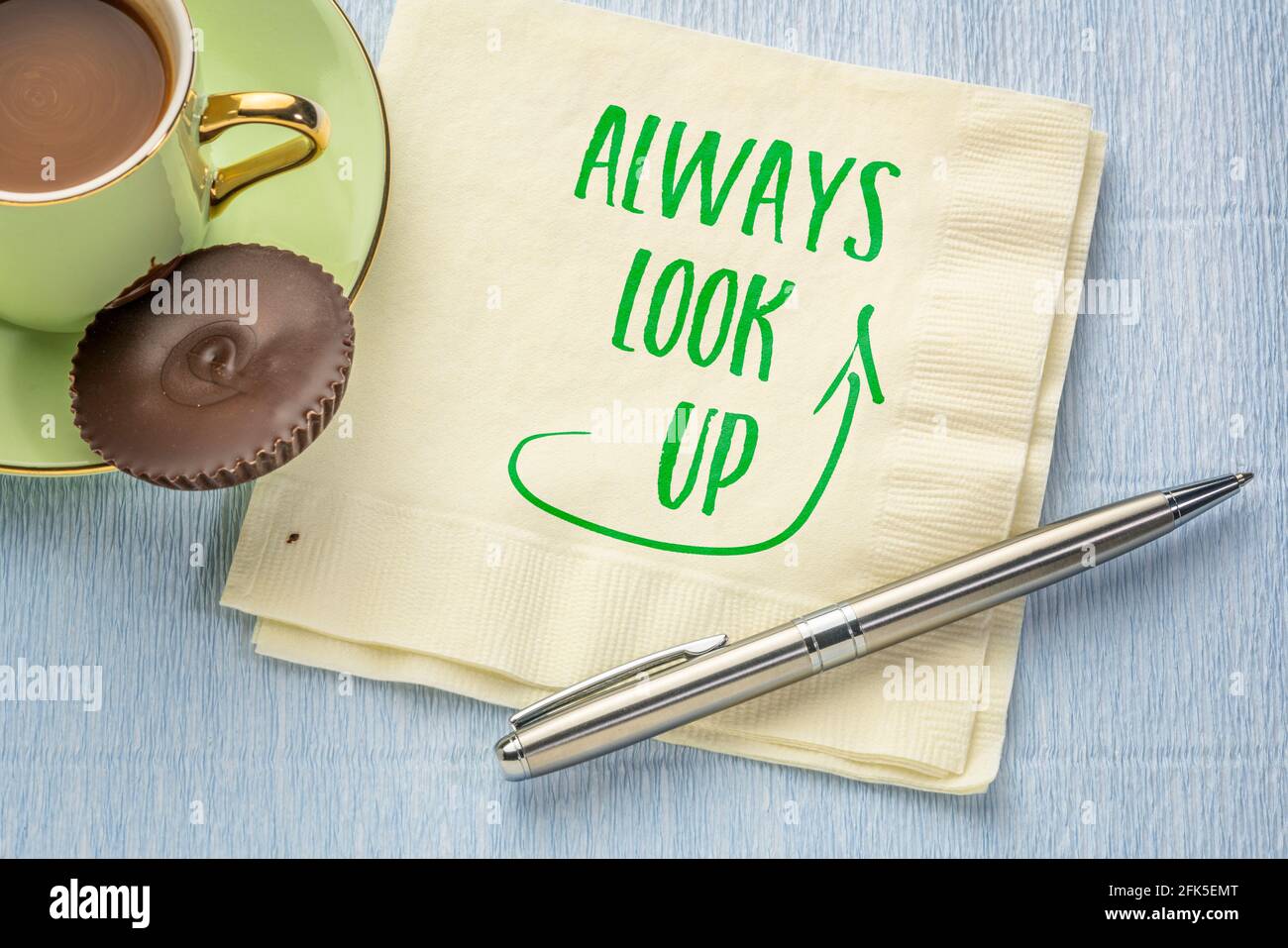 always look up - inspirational note on a napkin with a cup of coffee Stock Photo