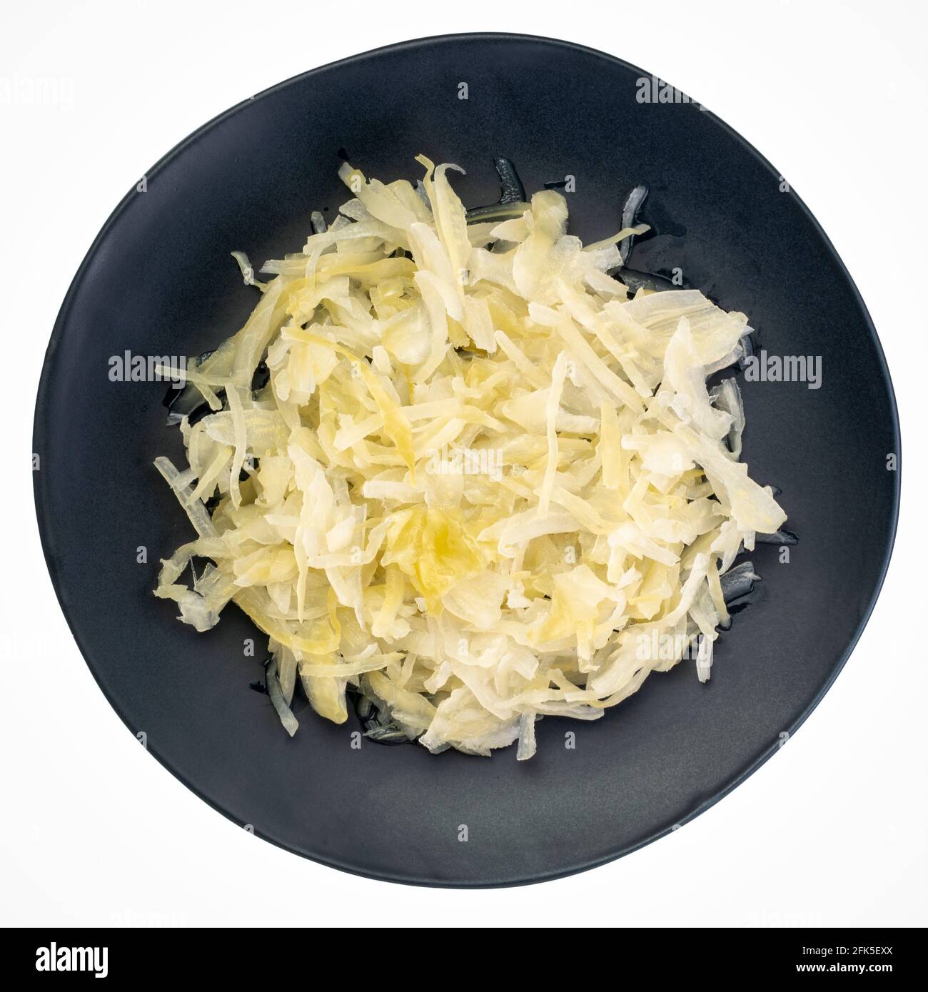 sauerkraut on an isolated, black plate, prebiotics concept - fermented food good for gut health Stock Photo