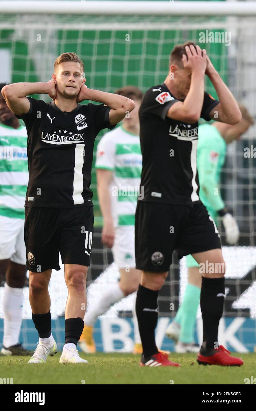 28 April 2021, Bavaria, Fürth: Football: 2. Bundesliga, SpVgg Greuther Fürth - SV Sandhausen, Matchday 28, at Sportpark Ronhof Thomas Sommer. Kevin Behrens (l) and Emanuel Taffertshofer of SV Sandhausen react to the match delay. Photo: Daniel Karmann/dpa - IMPORTANT NOTE: In accordance with the regulations of the DFL Deutsche Fußball Liga and/or the DFB Deutscher Fußball-Bund, it is prohibited to use or have used photographs taken in the stadium and/or of the match in the form of sequence pictures and/or video-like photo series. Stock Photo