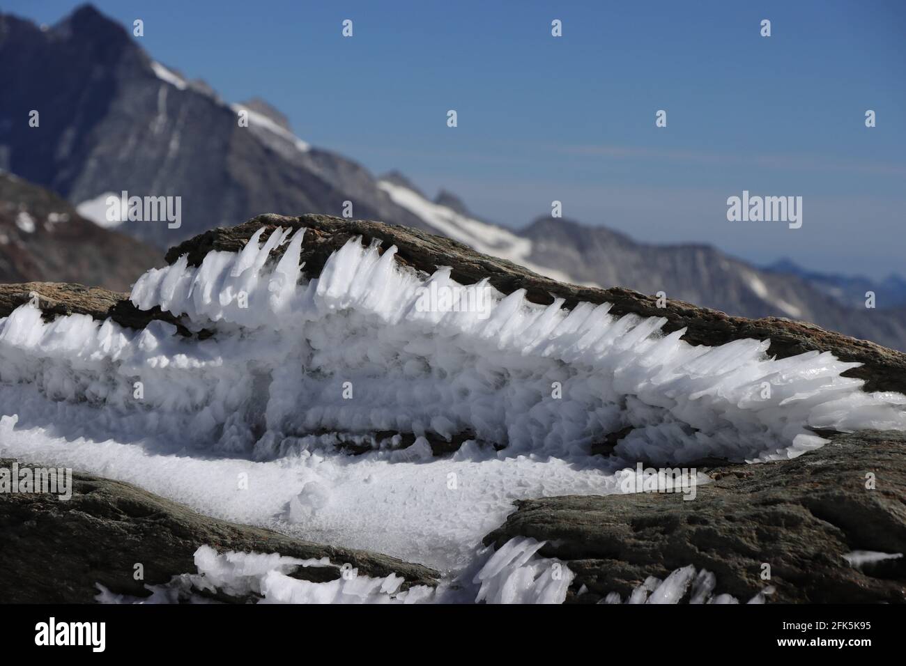 Small rock cave with ice needles. Jungfraujoch, Swiss Alps. Stock Photo